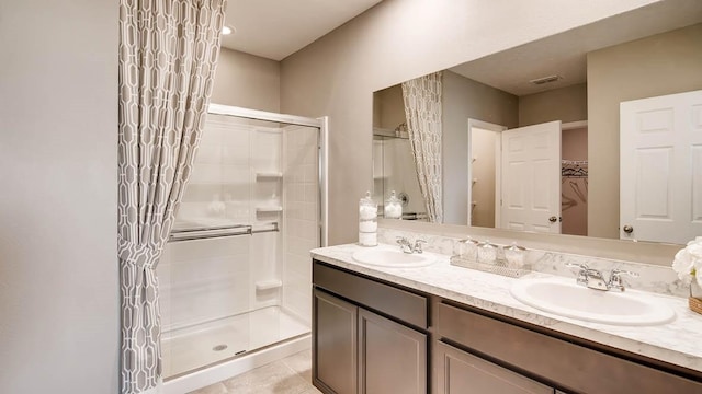 bathroom featuring vanity, tile patterned floors, and a shower with door