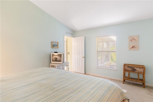 bedroom with light carpet and lofted ceiling