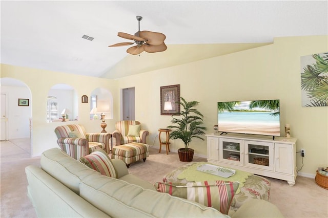 carpeted living room with ceiling fan and vaulted ceiling