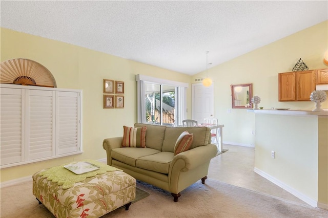 living room with vaulted ceiling and a textured ceiling