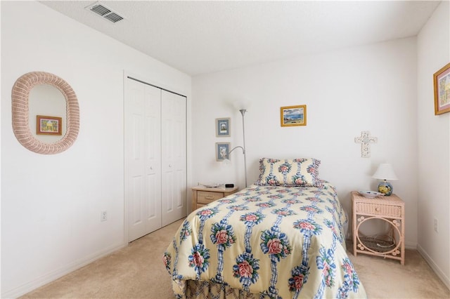 carpeted bedroom with a closet