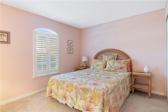 carpeted bedroom featuring multiple windows