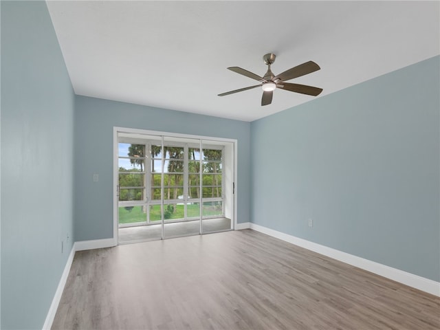 spare room featuring light hardwood / wood-style floors and ceiling fan