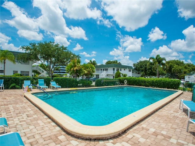 view of swimming pool with a patio