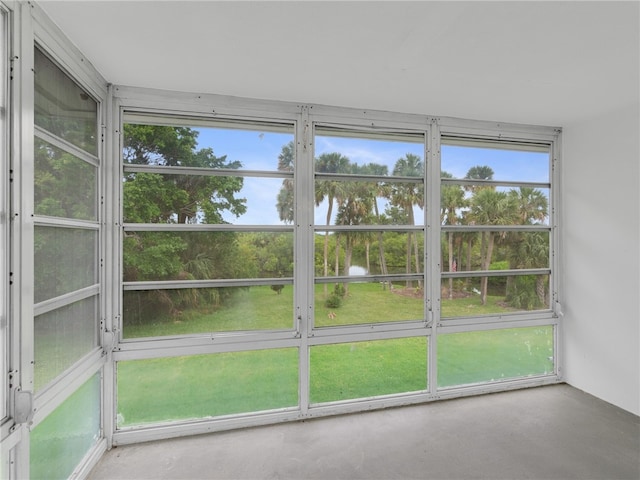 unfurnished sunroom with plenty of natural light and a water view