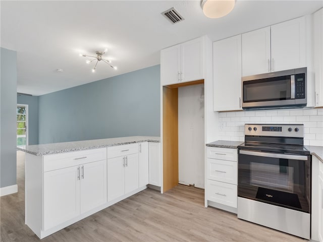 kitchen featuring white cabinetry, appliances with stainless steel finishes, and light hardwood / wood-style flooring