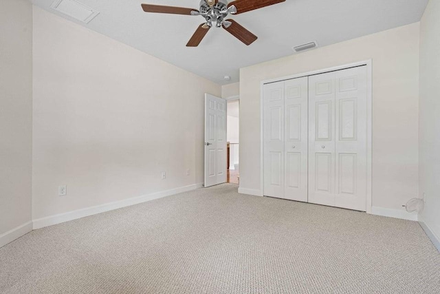 unfurnished bedroom featuring light carpet, a closet, and ceiling fan