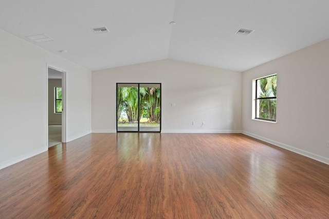 empty room featuring wood-type flooring and lofted ceiling