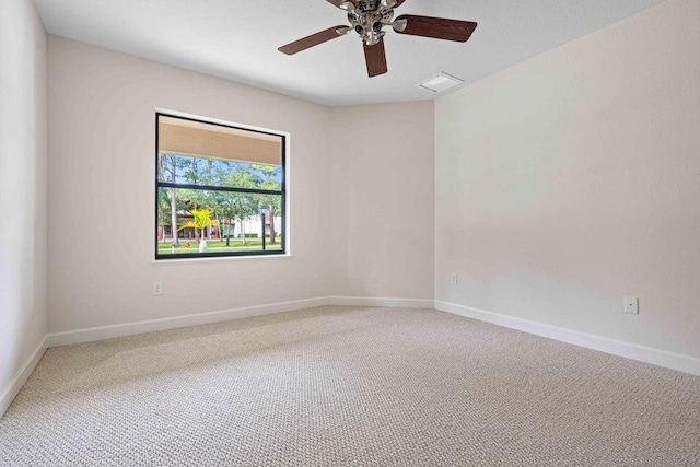 carpeted empty room featuring ceiling fan