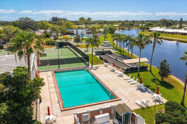 view of swimming pool featuring a water view