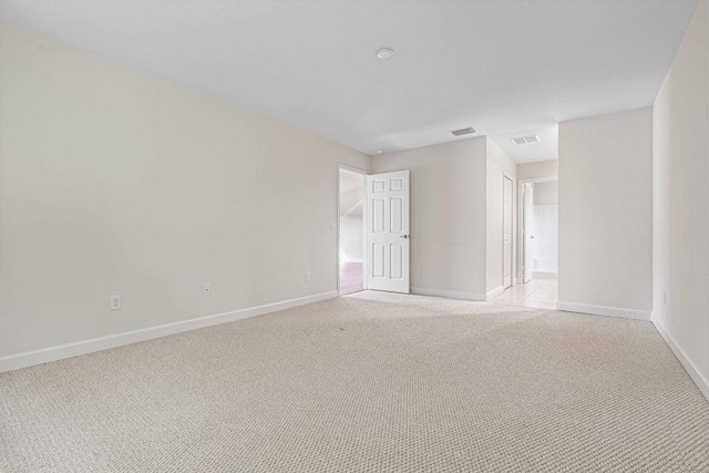 unfurnished room featuring light colored carpet