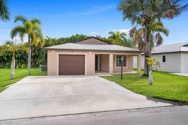 ranch-style house featuring a front yard, a garage, and cooling unit