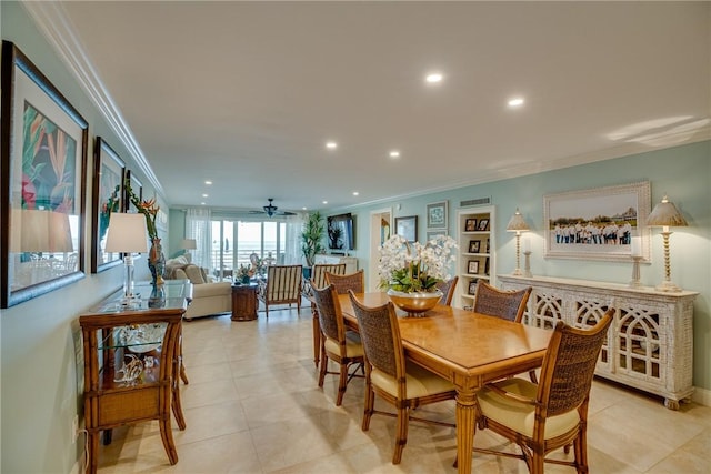 dining space with ceiling fan, ornamental molding, built in shelves, and light tile patterned floors