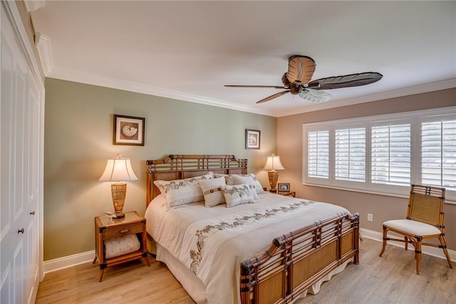 bedroom with ornamental molding, ceiling fan, and a closet