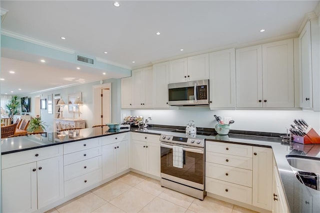 kitchen with light tile patterned floors, appliances with stainless steel finishes, crown molding, and white cabinetry