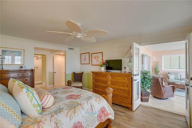 bedroom featuring ornamental molding, ceiling fan, and light wood-type flooring