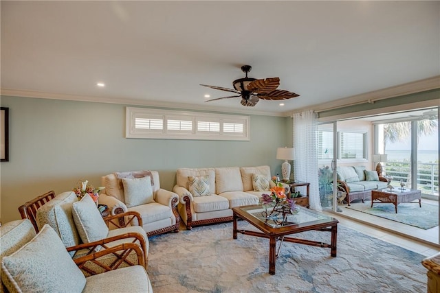 living room with ceiling fan and ornamental molding