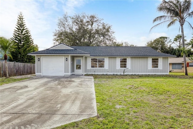 single story home featuring a garage and a front lawn