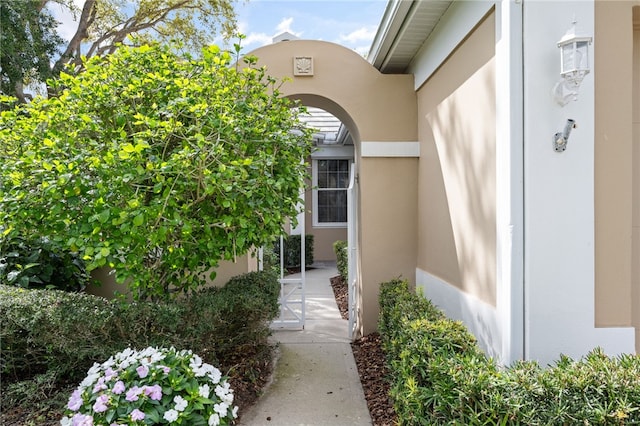 property entrance with stucco siding