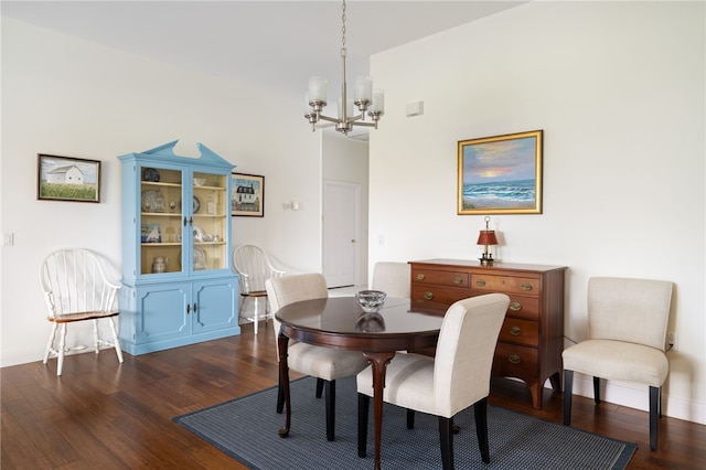 dining room featuring baseboards, dark wood-type flooring, and a notable chandelier