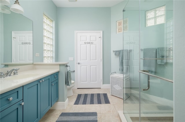 bathroom featuring baseboards, toilet, tile patterned floors, vanity, and a shower stall