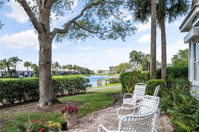 view of yard with a water view and a patio