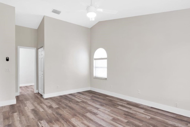 spare room featuring hardwood / wood-style flooring, lofted ceiling, and ceiling fan