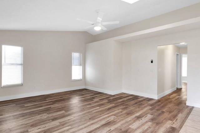 unfurnished room with lofted ceiling, hardwood / wood-style floors, and ceiling fan