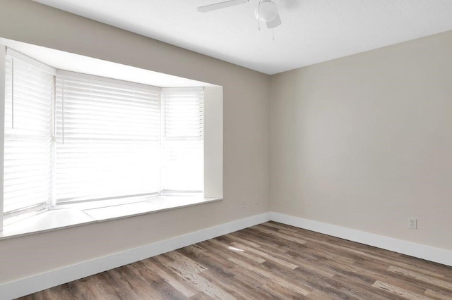 spare room with ceiling fan and hardwood / wood-style floors