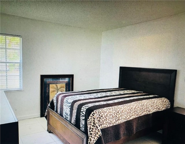 tiled bedroom featuring a fireplace