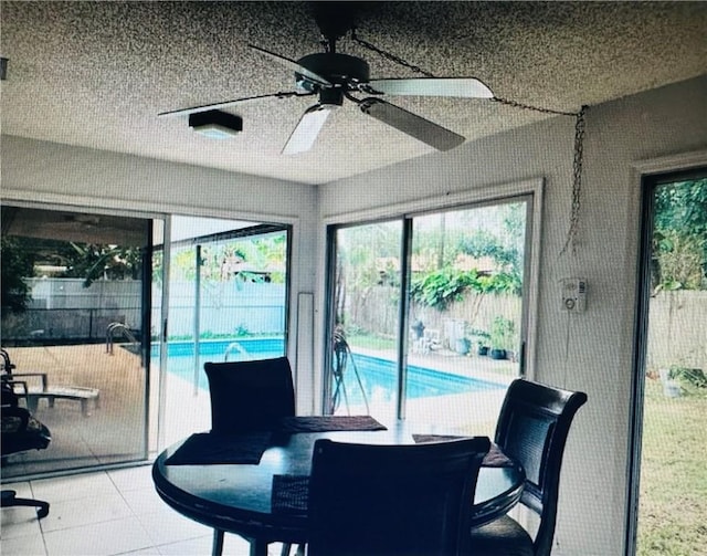 sunroom featuring ceiling fan