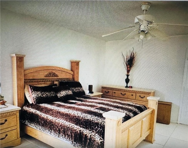 bedroom with ceiling fan and light tile patterned flooring