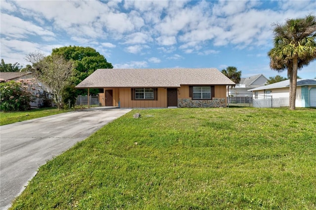 ranch-style house with stone siding, concrete driveway, a front lawn, and fence