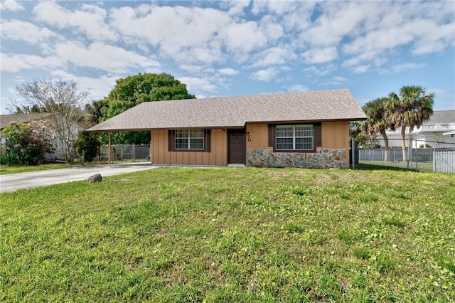 ranch-style home featuring stone siding, concrete driveway, a front yard, and fence