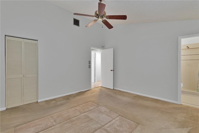 unfurnished bedroom with visible vents, baseboards, carpet, and high vaulted ceiling