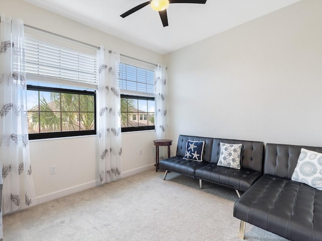 carpeted living room with ceiling fan