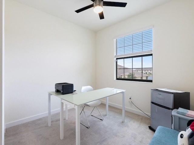 home office featuring ceiling fan and light colored carpet