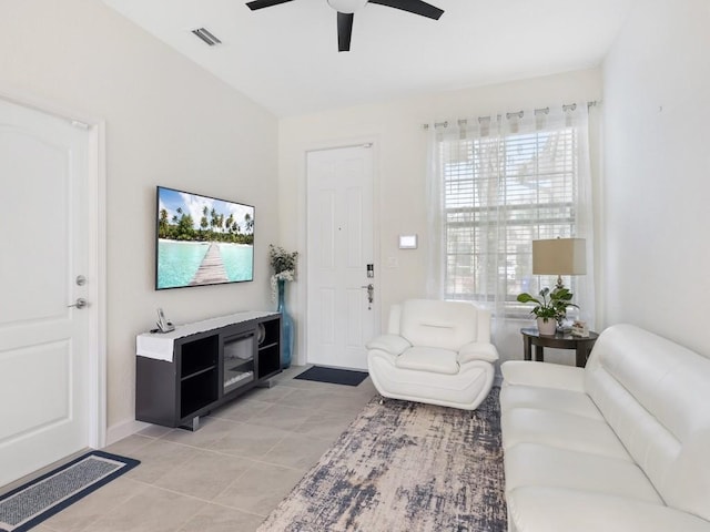 tiled living room featuring ceiling fan