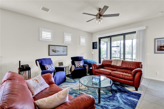 tiled living room featuring ceiling fan