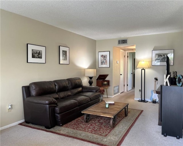 carpeted living room featuring a textured ceiling