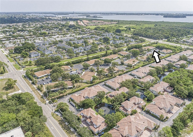 birds eye view of property with a residential view and a water view