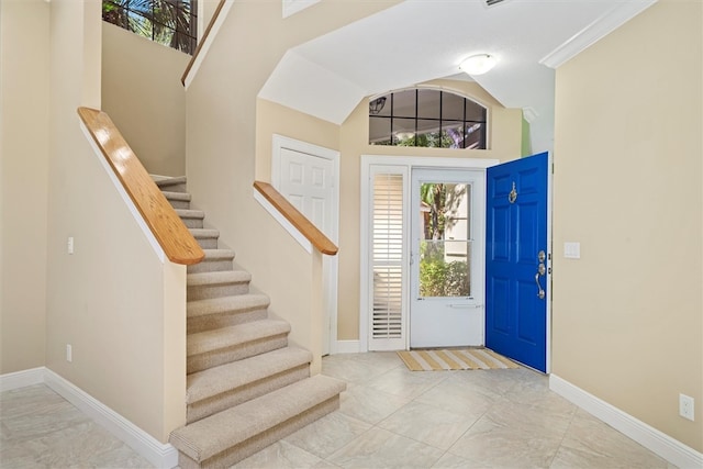 1619 Bent Oak Ln, Vero Beach, FL 32963 - entryway featuring healthy amount of natural light, stairway, marble look tile flooring, and baseboards