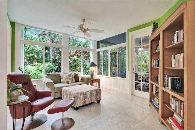 sunroom / solarium featuring a healthy amount of sunlight and ceiling fan