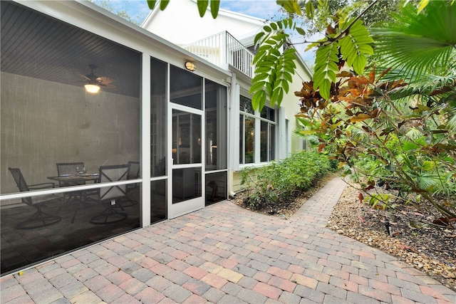 view of patio / terrace with a sunroom and a balcony