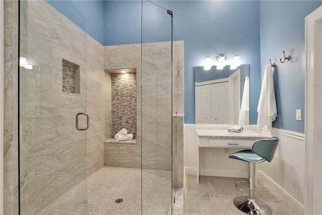 1619 Bent Oak Ln, Vero Beach, FL 32963 - bathroom with a stall shower and wainscoting
