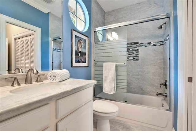 full bathroom featuring vanity, combined bath / shower with glass door, and toilet