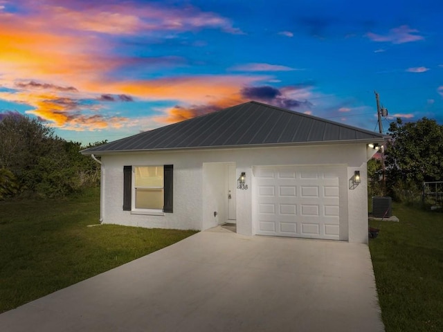 ranch-style home featuring a yard and central AC