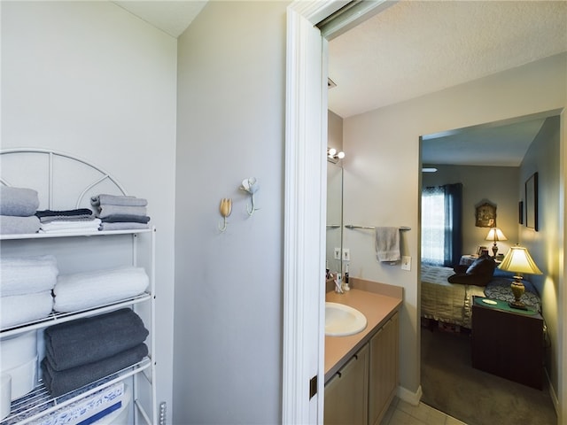 bathroom with tile patterned floors and vanity