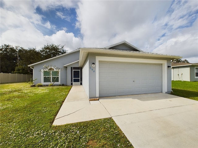 ranch-style house featuring a garage and a front lawn