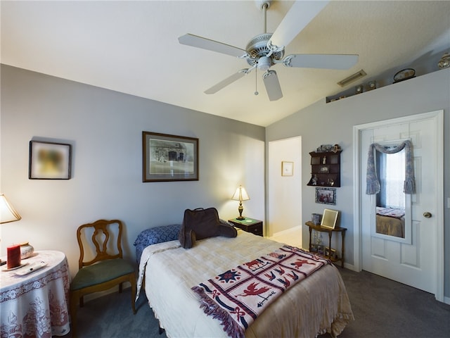 bedroom featuring ceiling fan, dark carpet, and vaulted ceiling